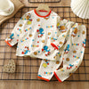 A white long-sleeve cotton pajama set for children featuring colorful bears and stars on a grid background.