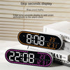 An orange digital alarm clock displaying 8:08 with a leap second display, resting on a white surface.