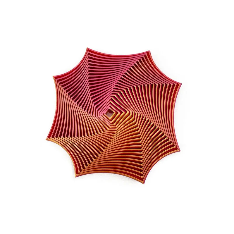Et geometrisk fidget-leketøy med optisk illusjon-design, røde og oransje konsentriske linjer.
