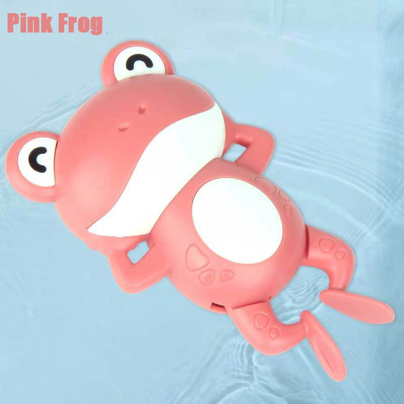 A pink frog bath toy is shown floating in clear water.