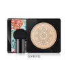 Base BB cushion negra con aplicador de hongo y empaque floral.