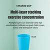 A bright blue multi-layer stacking cup is shown against a light green background.