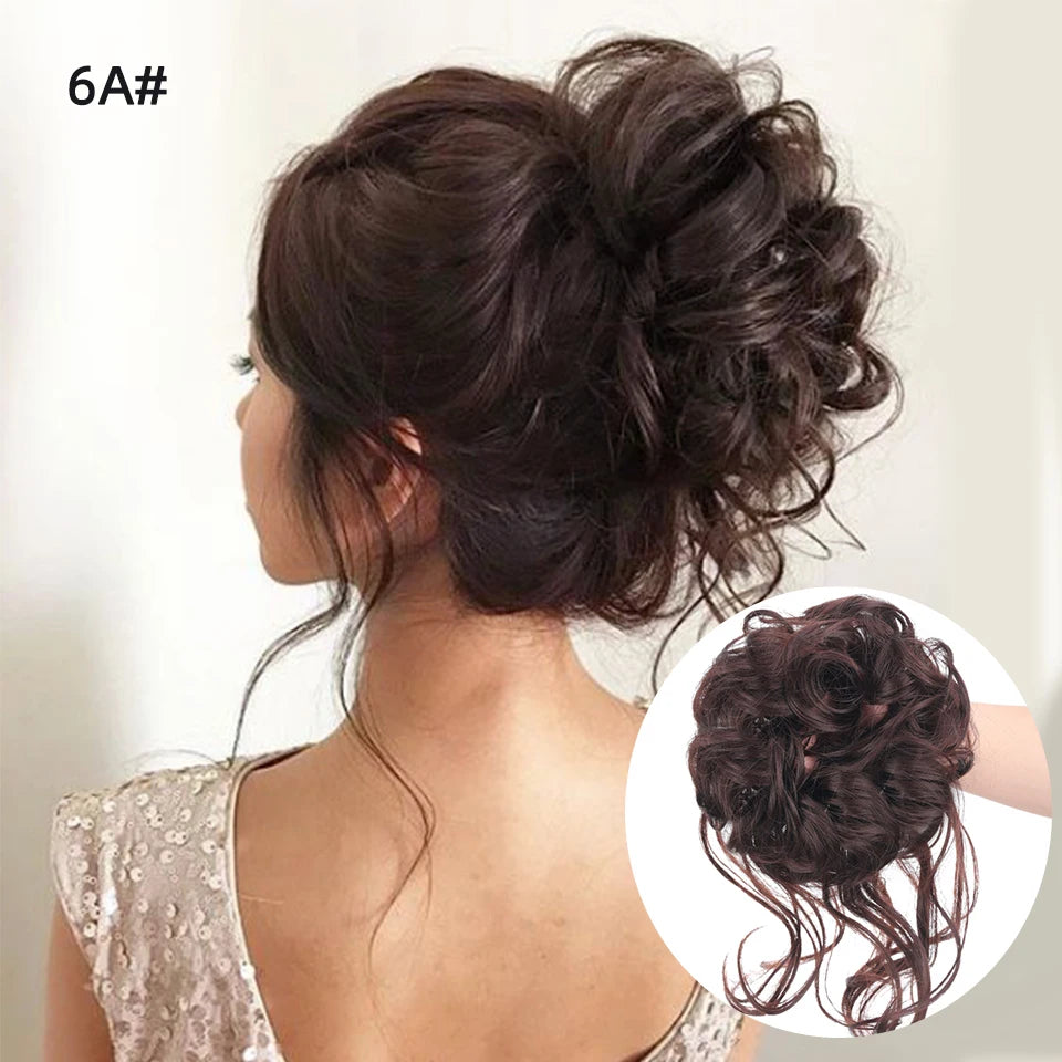 Moño de cabello castaño oscuro con rizos desordenados asegurado con una banda elástica.