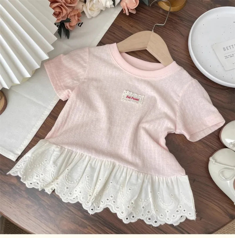 Pink girls cotton short sleeve tee with white lace hem and a small embroidered tag