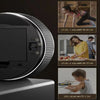 A black magnetic kitchen timer with a rotary dial showing volume levels and a person using it.