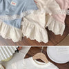 A stack of girls cotton lace hem short sleeve tees in light blue, cream, and pink.