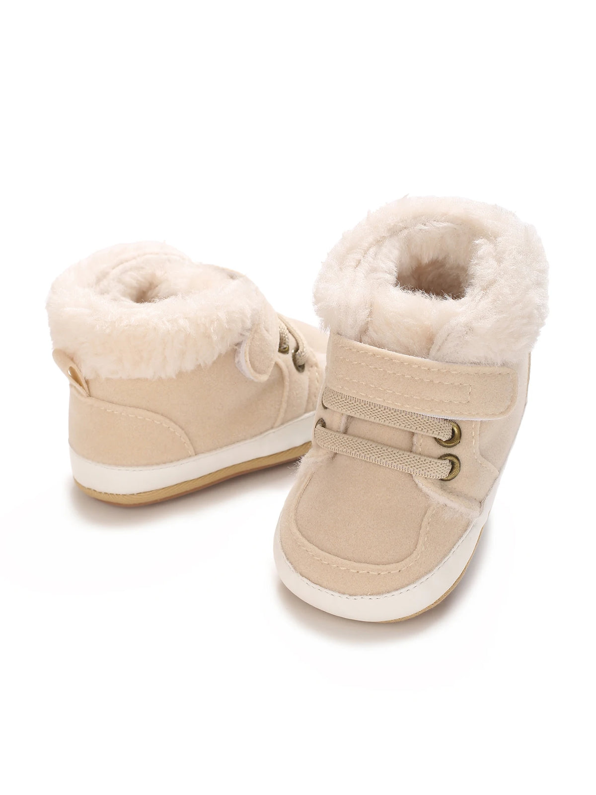 A pair of beige baby winter snow boots with fluffy shearling lining and light tan suede upper.