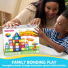 A smiling woman is helping a young boy build a colorful magnetic tile structure for family bonding play.
