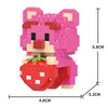 A pink Lego-style animal figurine of a bear with a red strawberry attached, shown from the side.