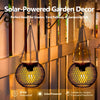 Solar-powered metal hanging lantern with a mesh design used for garden and outdoor decor