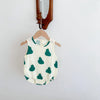 A white sleeveless baby jumpsuit bodysuit with green leaf patterns hanging on a wooden hanger.