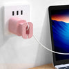 A pink silicone charger protector and cable organizer is mounted on a white electrical outlet on a wall.