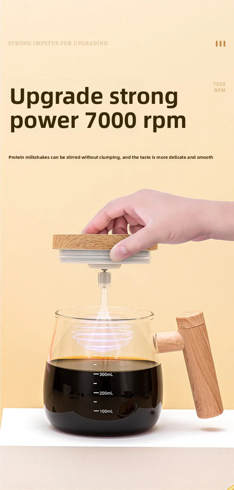 A hand is stirring a dark liquid in a glass mug using a rechargeable self-stirring device with a wooden handle.
