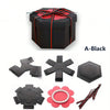 A black gift box kit with red ribbon and accompanying explosion surprise elements.