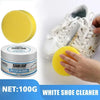 A yellow cleaning cream and sponge are shown next to a white sneaker for shoe cleaning.