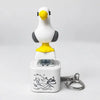 A white and yellow seagull-shaped fidget toy keychain with a light feature.