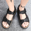 A pair of black men's genuine leather air cushion sandals worn on a person's feet.