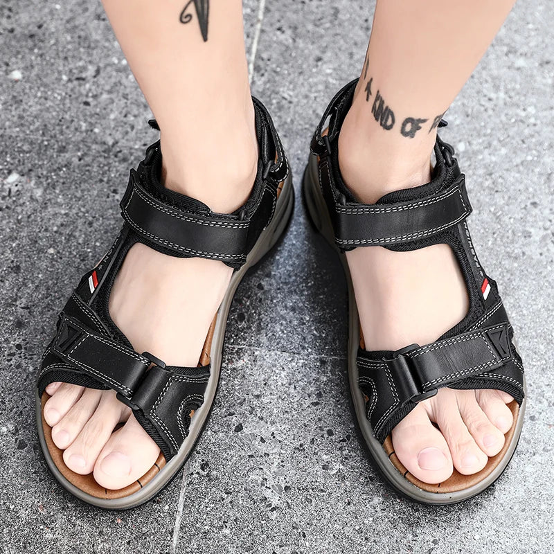 A pair of black men's genuine leather air cushion sandals worn on a person's feet.