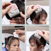 Hands show a pink and white 2-in-1 manual hair trimmer comb being used on a baby's hair.