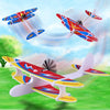 A red and blue LED foam glider airplane toy flying in the sky against a bright blue background.