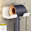 Soporte de pared para secador de pelo con bandeja blanca y copa de secado color cobre sobre soporte gris oscuro.