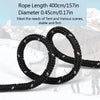 Black rope coiled and laid out against a snowy mountain background.