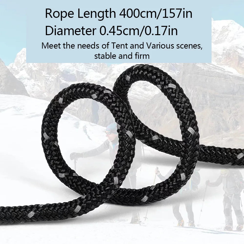 Black rope coiled and laid out against a snowy mountain background.