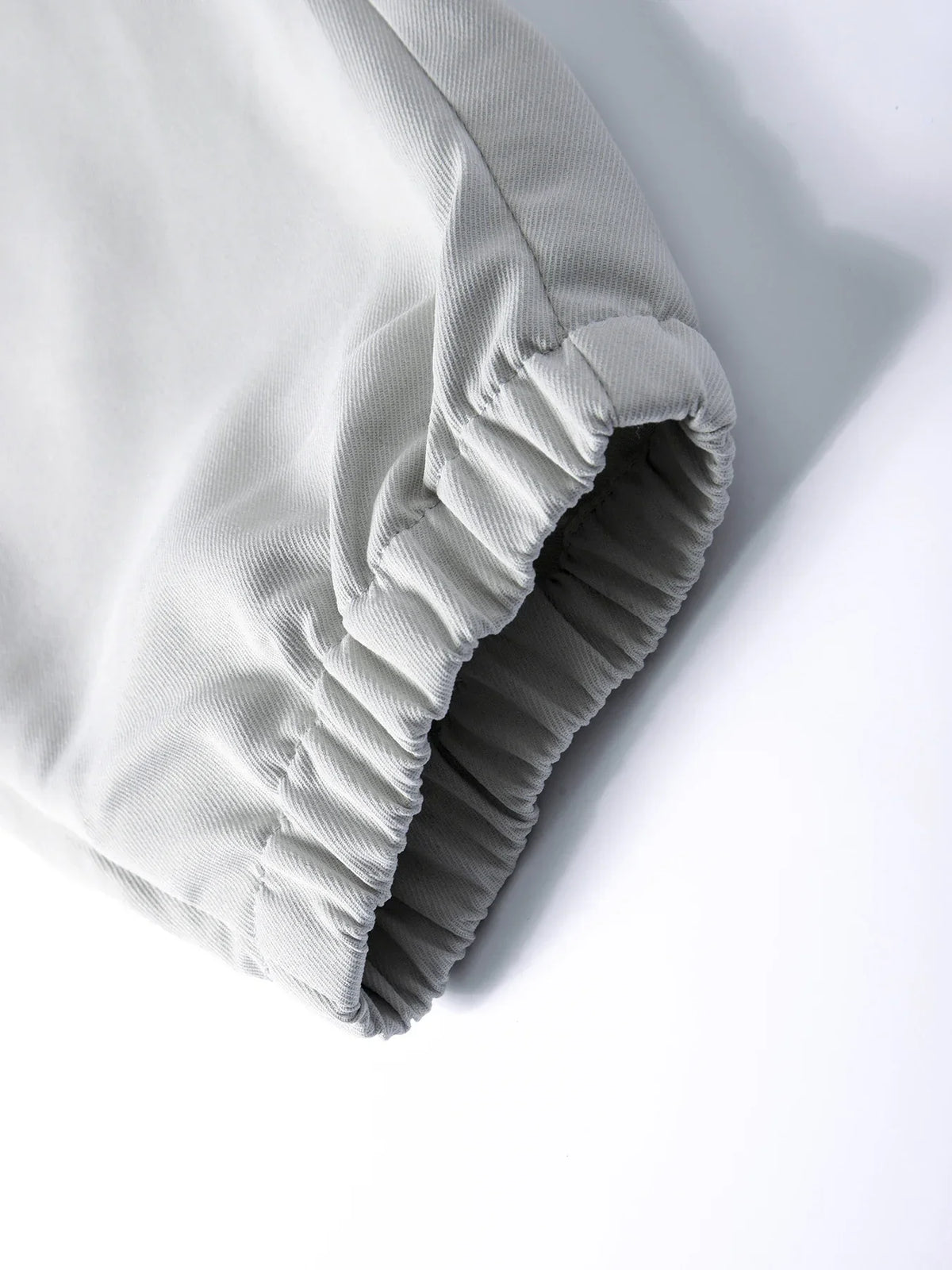 Light gray men's cargo joggers with an adjustable elasticated cuff shown from the side.