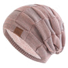 A pink knit beanie with a textured pattern and a light pink faux fur trim.