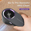 A hand holds a Mini Hairball Trimmer device with a dark gray body and purple accents, demonstrating its use.