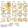 A set of gold rings featuring various designs including hearts, geometric shapes, crosses, and butterfly motifs.