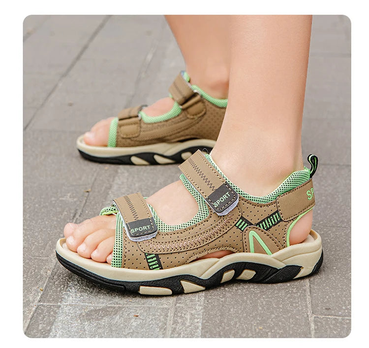 A close-up of a pair of tan and lime green breathable summer sport sandals for boys, showing the adjustable straps and sole.