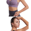 A woman models a purple breathable sports bra with mesh panels and padded support.