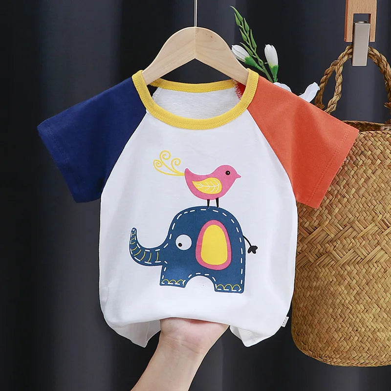 A white cartoon t-shirt featuring a blue elephant design with a pink bird on its back, displayed on a wooden hanger.