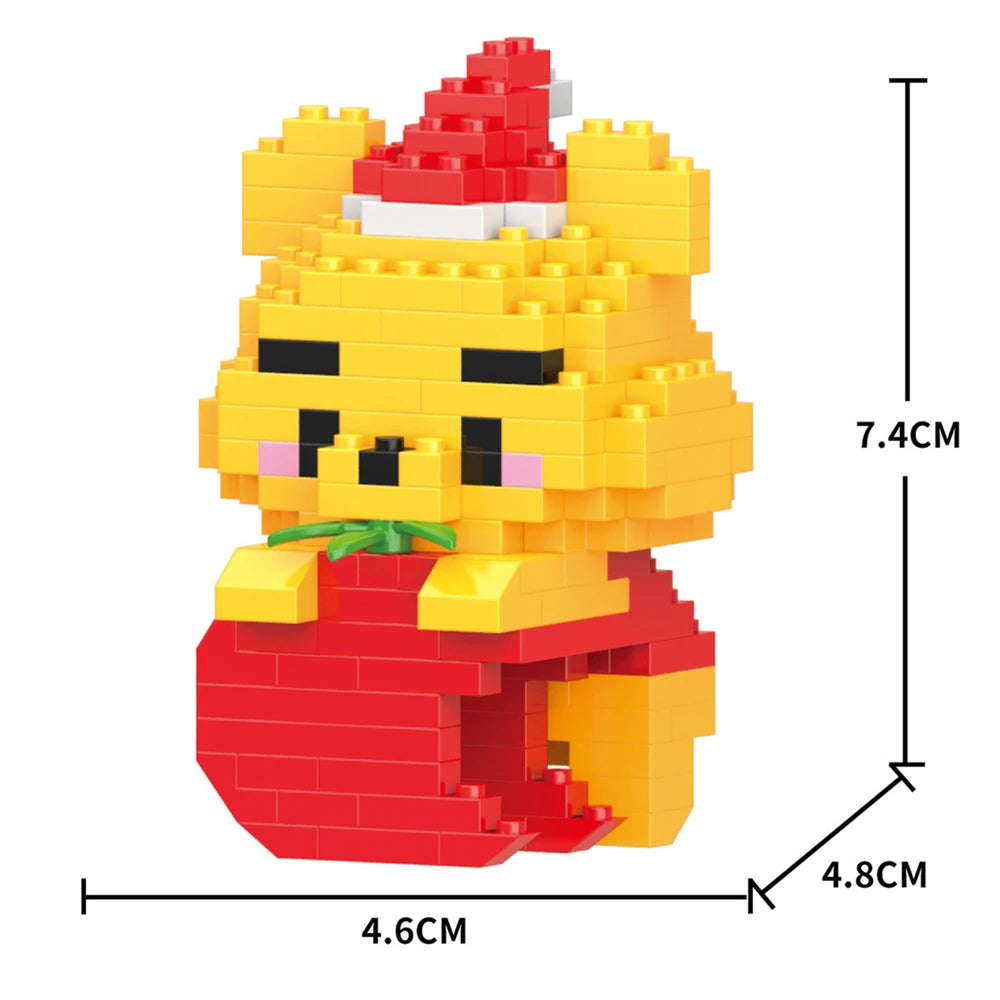 A yellow building block figurine of a bear wearing a red Santa hat and a red outfit.