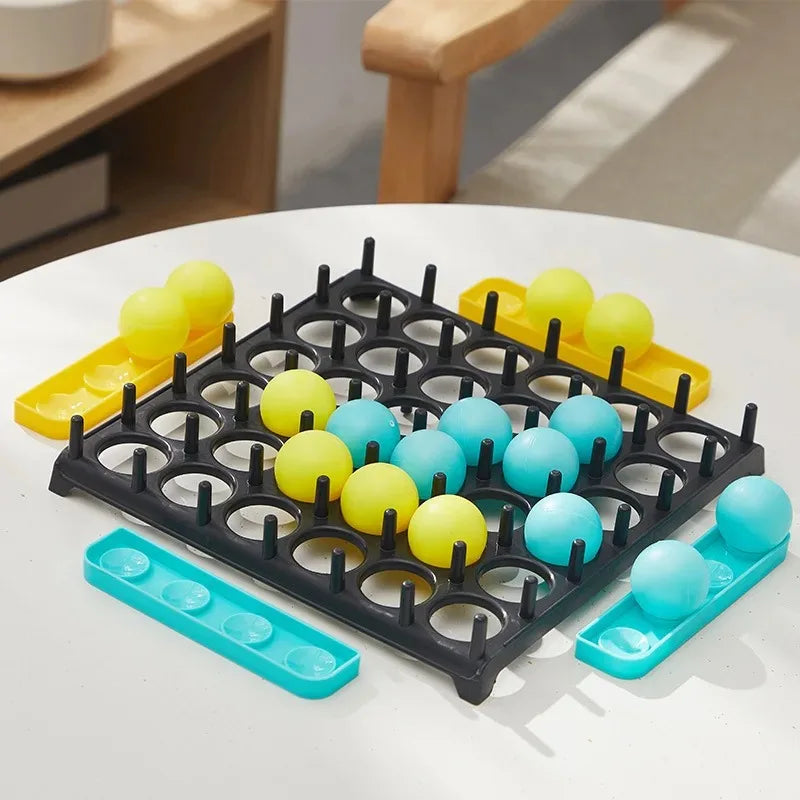 A black silicone mold tray with yellow and blue silicone balls for a tabletop game