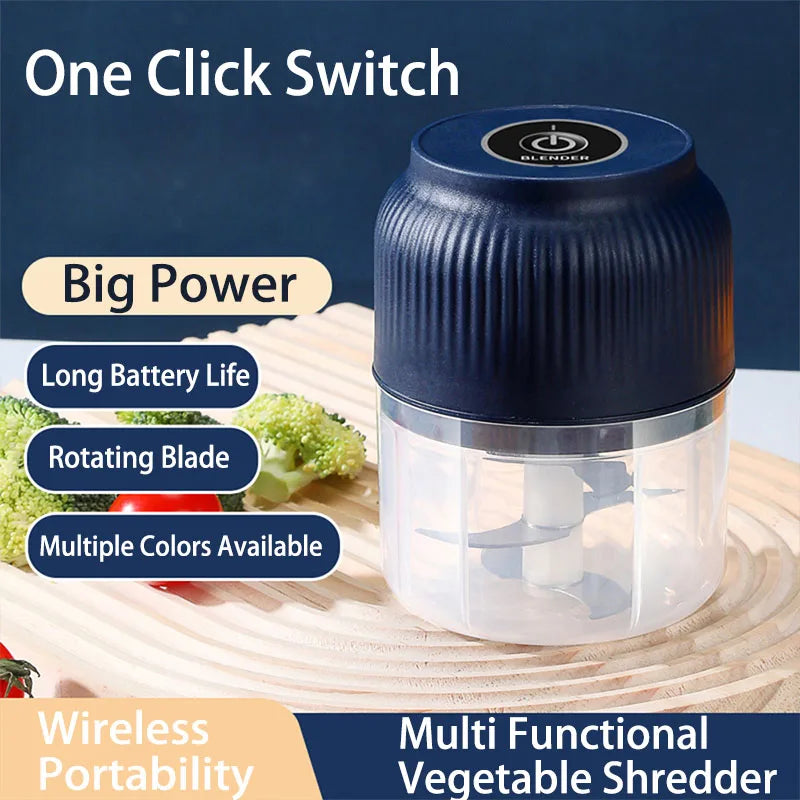 A blue and clear mini food chopper with a rotating blade is shown on a wooden surface.
