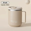 A beige double wall insulated stainless steel travel mug with a silver lid and handle.