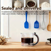 A set of blue and gray silicone spatulas and a glass measuring cup are displayed on a wooden counter.