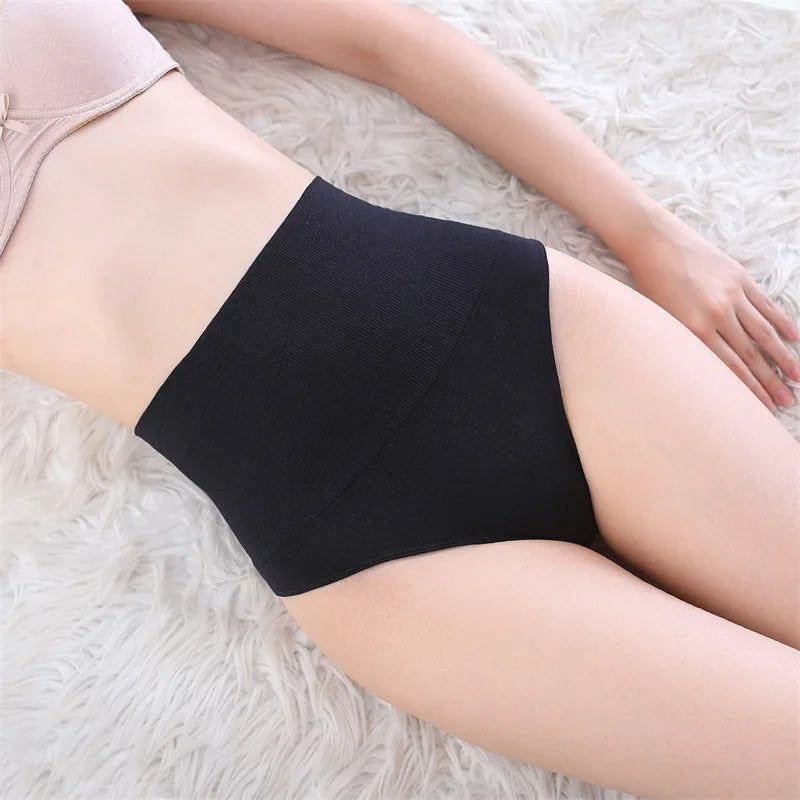 Black high-waist tummy control butt lifter thong shaper worn on a person's lower body.
