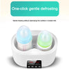 A white multi-function baby bottle warmer and sterilizer device with a clear bottle component.