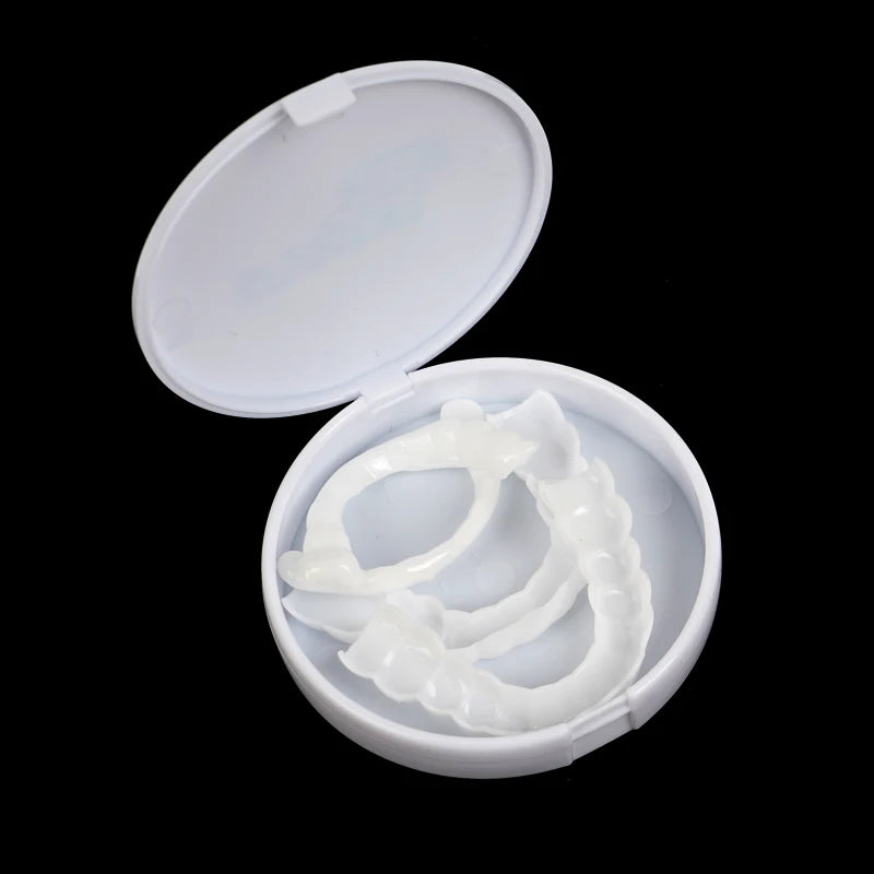 A white cosmetic denture teeth kit is displayed in an open white plastic container.