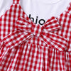 A red and white gingham cotton knit dress for girls featuring a bow detail.