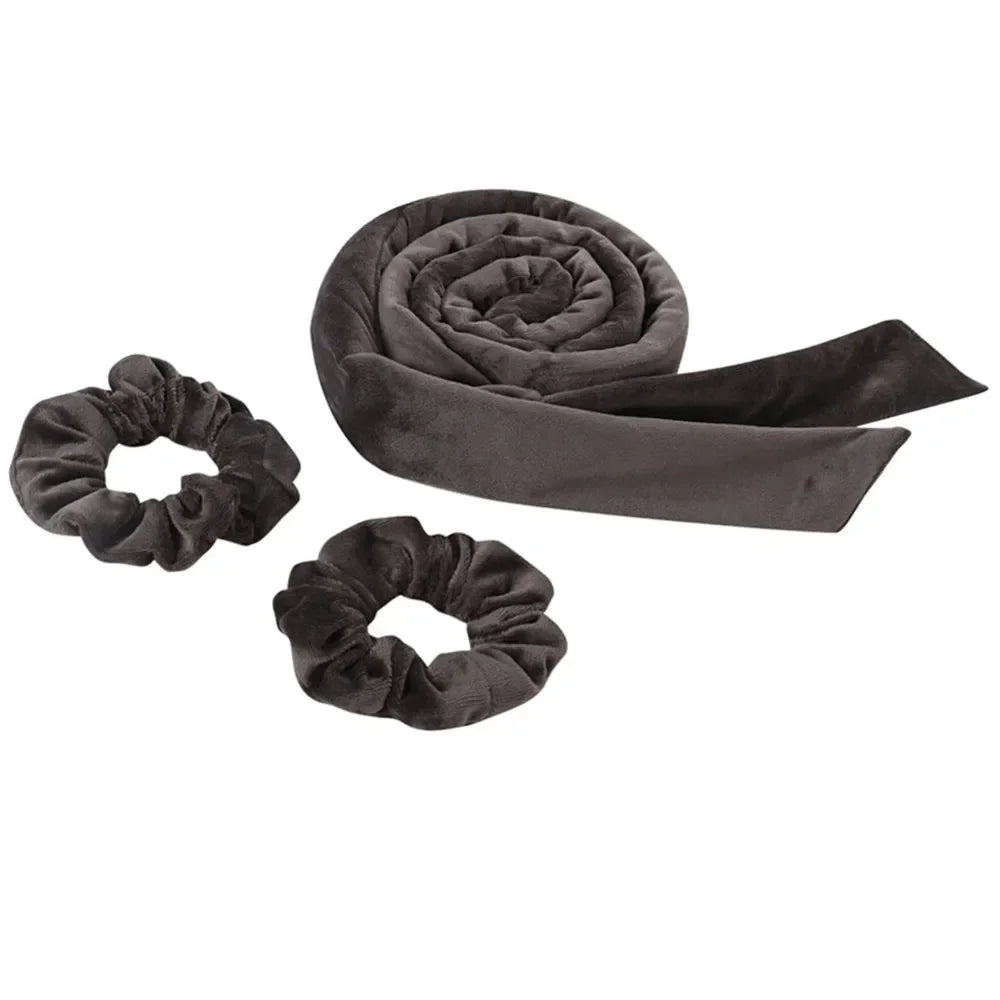A dark gray velvet heatless curling rod headband rolled into a spiral and a separate coiled version.