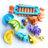 A set of orange and blue marble run building blocks with tracks, funnels, and various colored marbles.
