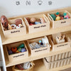 A wooden pretend play food cutting set with various foods like meat fish fruit and vegetables stored in divided wooden boxes.