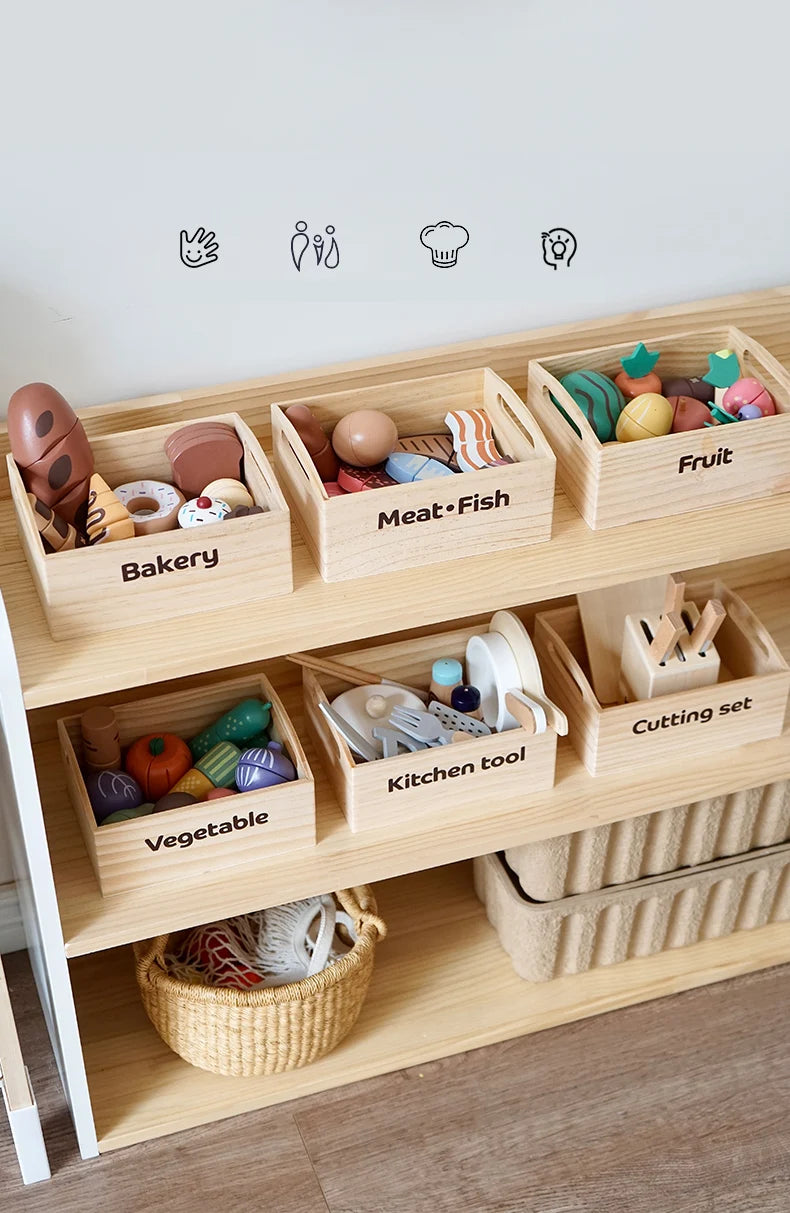 A wooden pretend play food cutting set with various foods like meat fish fruit and vegetables stored in divided wooden boxes.