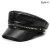 Black PU leather beret hat with a decorative silver studded band and a curved brim.