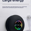 A black bathroom suction cup speaker is mounted on a white tile, with text describing its small size and large energy.