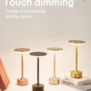 Four modern gold and bronze touch dimming desk lamps displayed on a white surface.